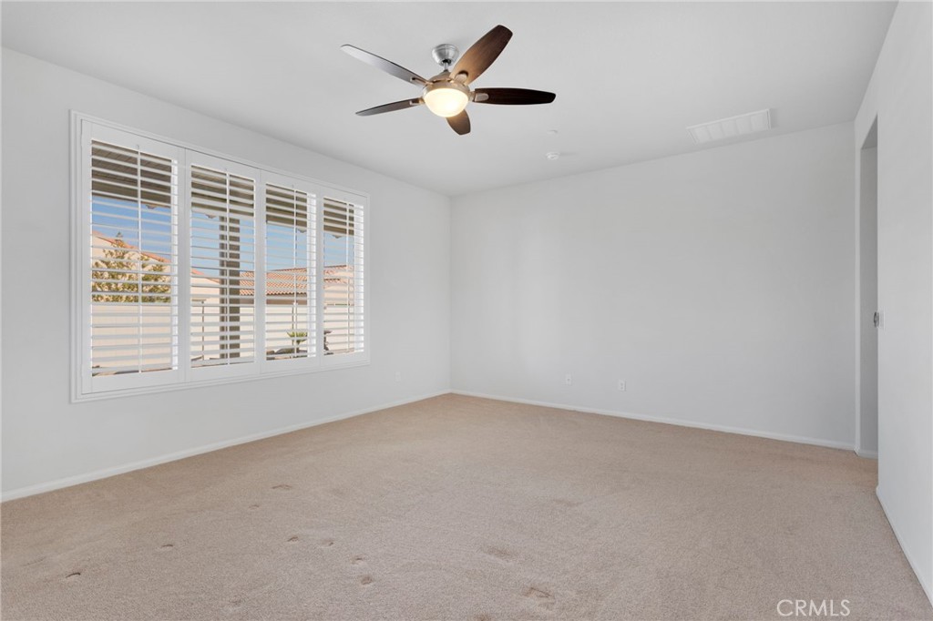 18968 Raven Street Apple Valley, CA 92308 - Photo 27 of 53 an empty room with a window and a ceiling fan