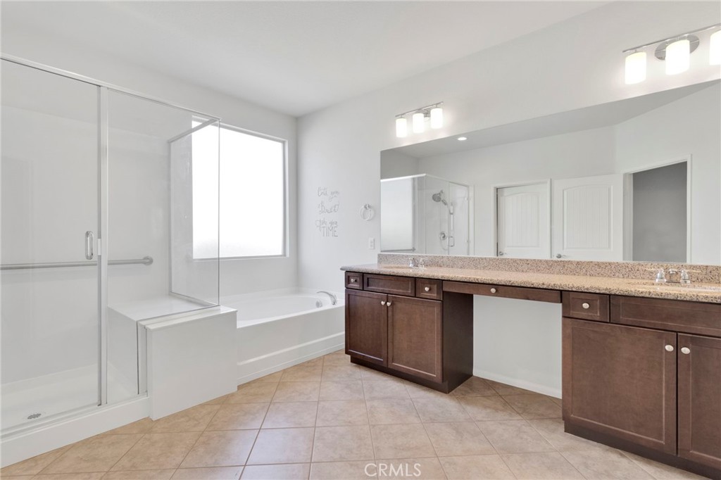 18968 Raven Street Apple Valley, CA 92308 - Photo 29 of 53 a large bathroom with a granite countertop sink and a bathtub