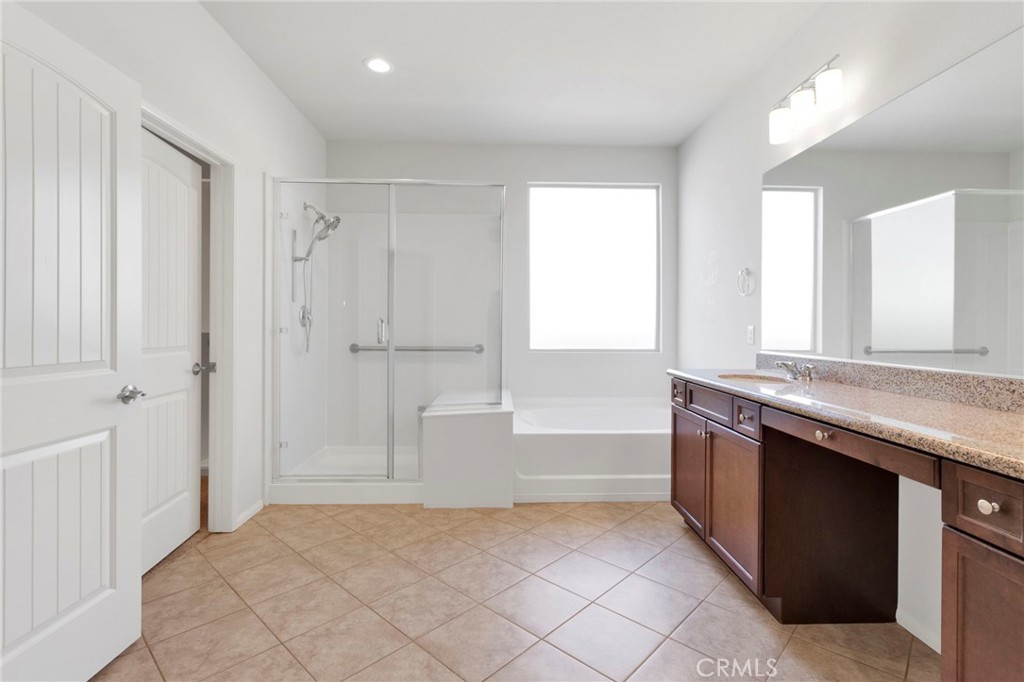 18968 Raven Street Apple Valley, CA 92308 - Photo 30 of 53 a bathroom with a granite countertop sink a toilet and bathtub