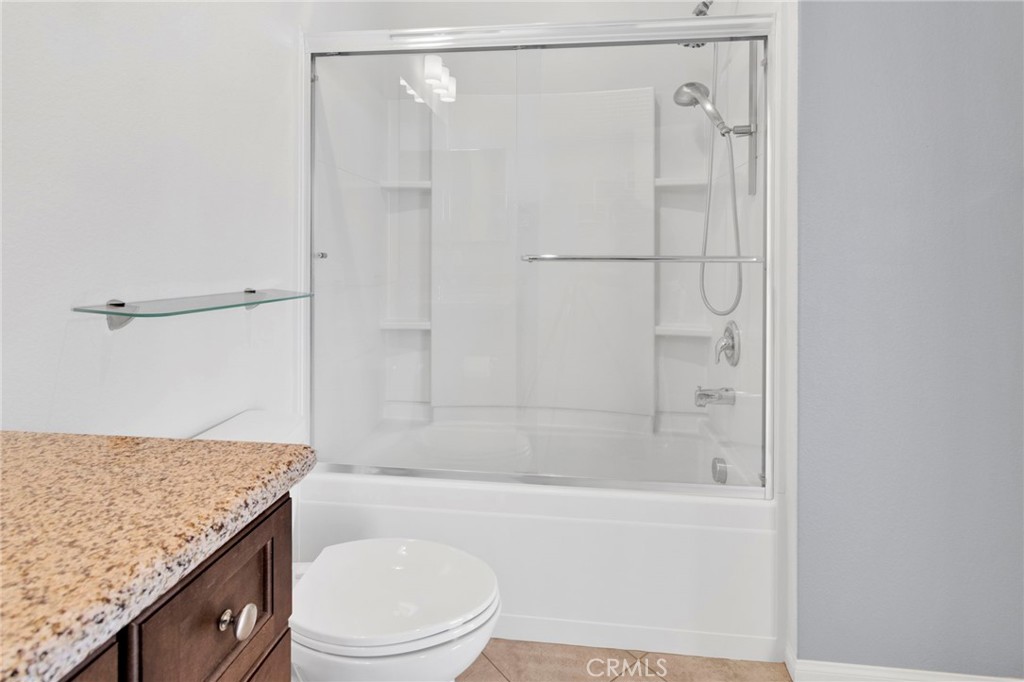 18968 Raven Street Apple Valley, CA 92308 - Photo 34 of 53 a bathroom with a granite countertop sink toilet and shower
