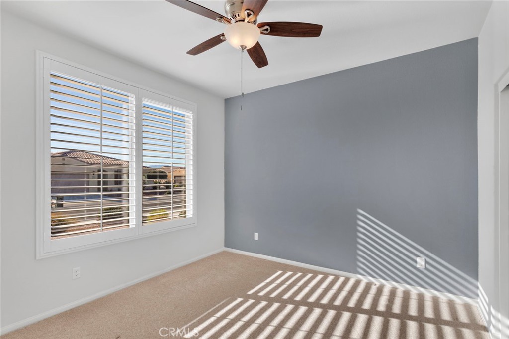 18968 Raven Street Apple Valley, CA 92308 - Photo 36 of 53 a view of an empty room with window and a ceiling fan