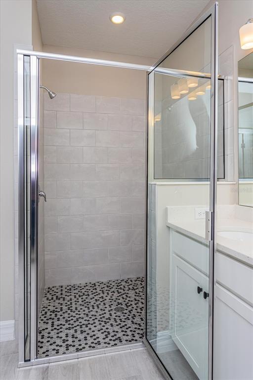 2031 Firethorn Loop Haines City, FL 33844 - Photo 13 of 20 a bathroom with a glass shower door