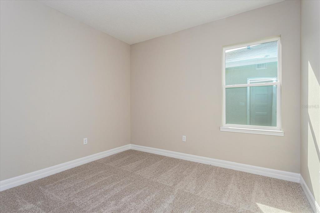 2031 Firethorn Loop Haines City, FL 33844 - Photo 15 of 20 an empty room with a window