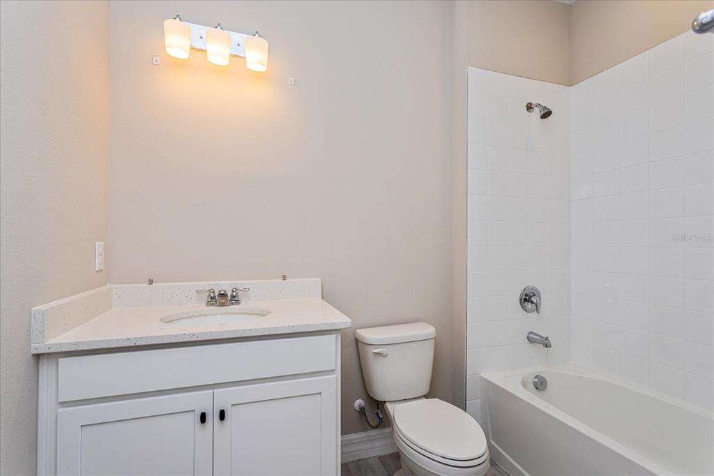 2031 Firethorn Loop Haines City, FL 33844 - Photo 17 of 20 a bathroom with a sink toilet and shower