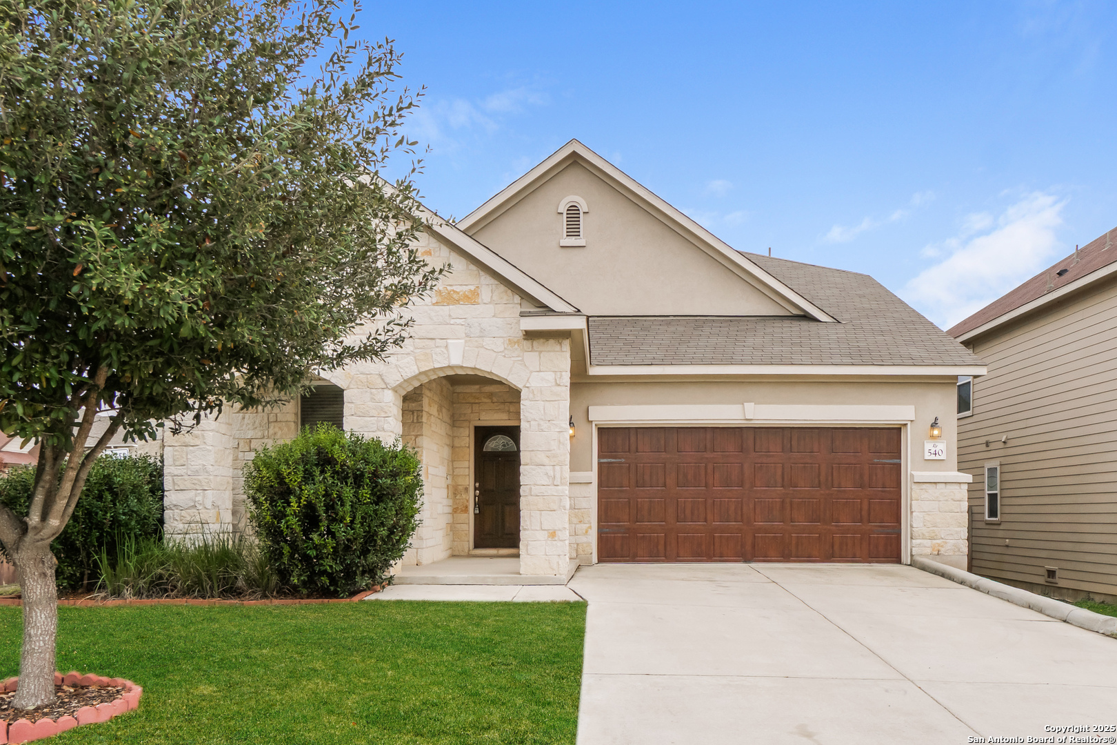 a front view of a house with a yard and garage