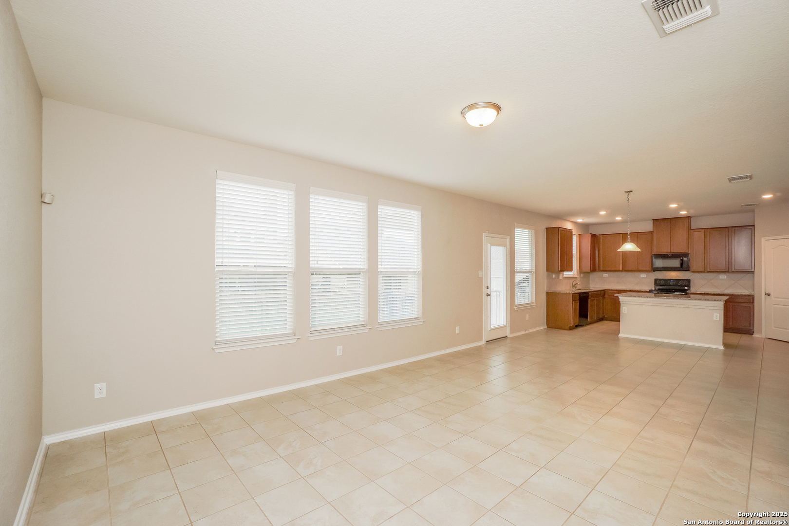 540 Landmark Gate Cibolo, TX 78108 - Photo 4 of 22 a view of a kitchen with kitchen island and windows