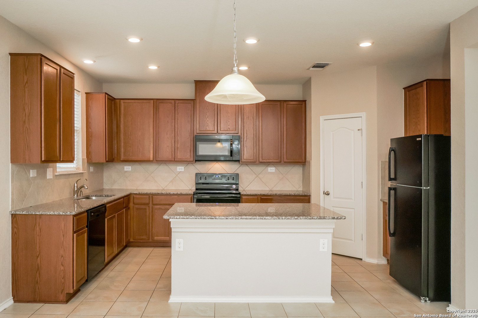 540 Landmark Gate Cibolo, TX 78108 - Photo 5 of 22 a kitchen with kitchen island granite countertop stainless steel appliances stove a sink and a refrigerator