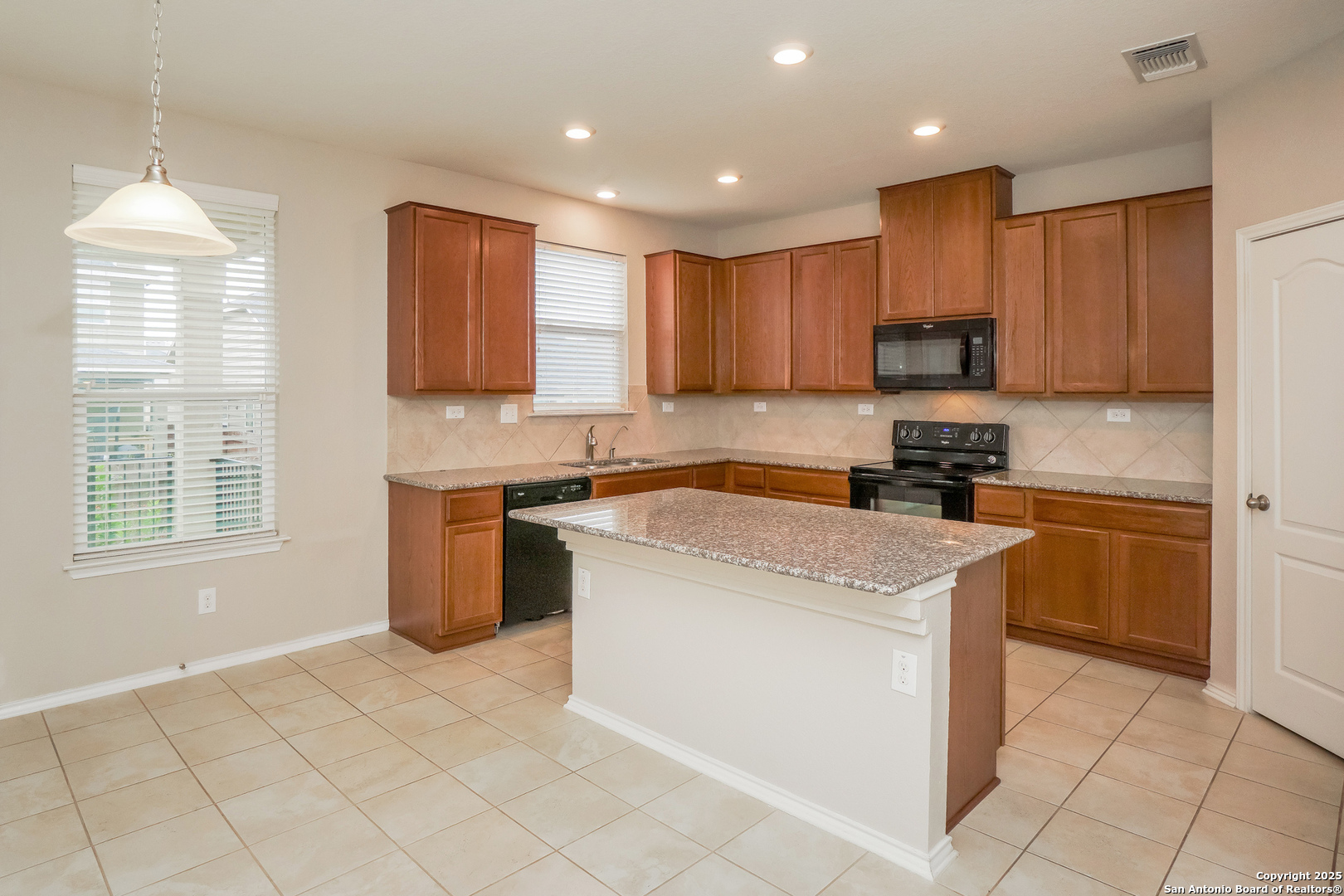 540 Landmark Gate Cibolo, TX 78108 - Photo 7 of 22 a kitchen with a stove a sink and a microwave