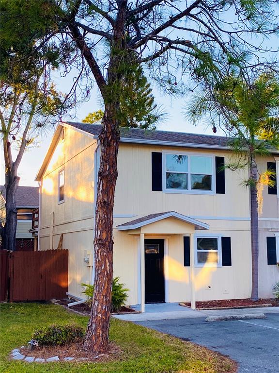 148 Douglas Road West, Unit C Oldsmar, FL 34677 - Photo 1 of 25 a front view of a house with garden