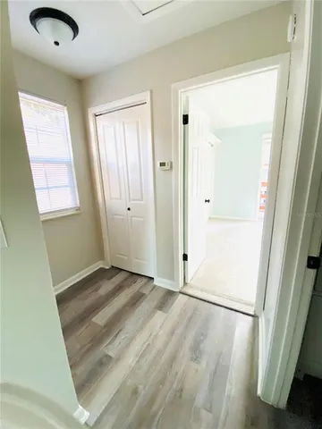 an empty room with closet and windows