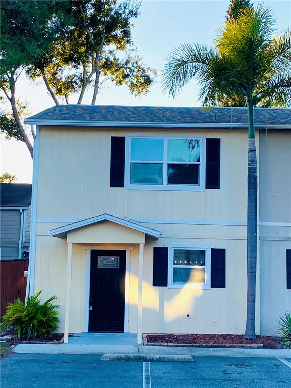 148 Douglas Road West, Unit C Oldsmar, FL 34677 - Photo 2 of 25 a front view of a house with yard