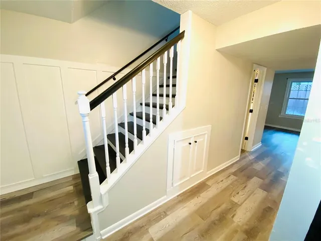 a view of an entryway with wooden floor