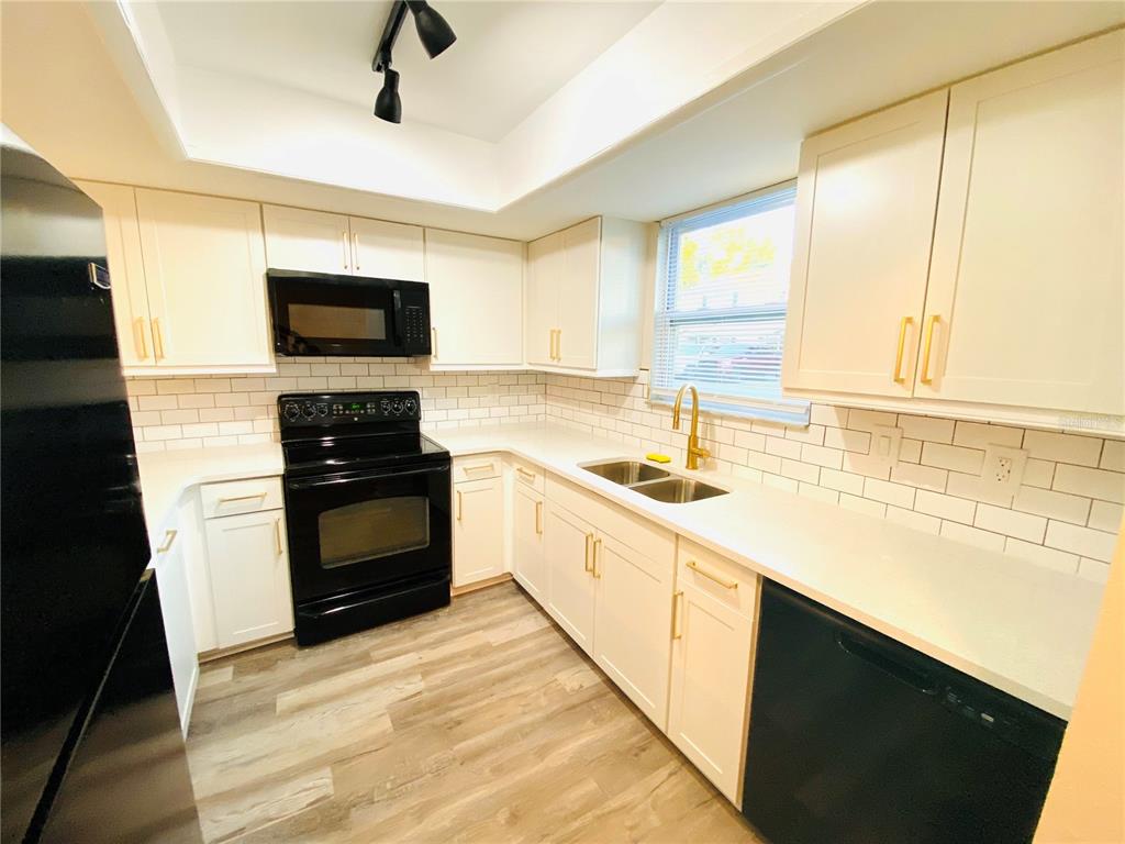 148 Douglas Road West, Unit C Oldsmar, FL 34677 - Photo 5 of 25 a kitchen with a sink stove and microwave