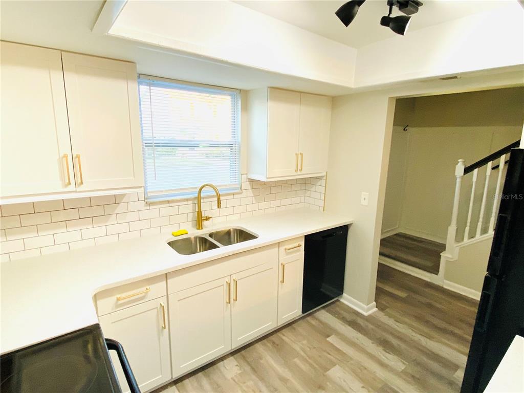 148 Douglas Road West, Unit C Oldsmar, FL 34677 - Photo 7 of 25 a kitchen with a sink and a window