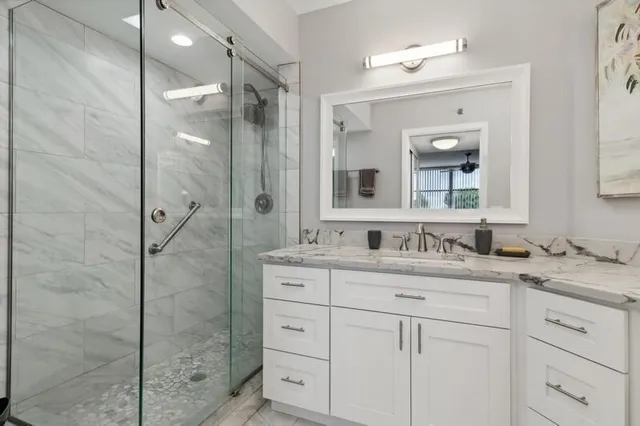 a bathroom with a granite countertop sink mirror and double