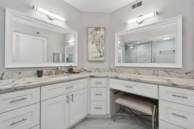 a spacious bathroom with a granite countertop sink mirror and double