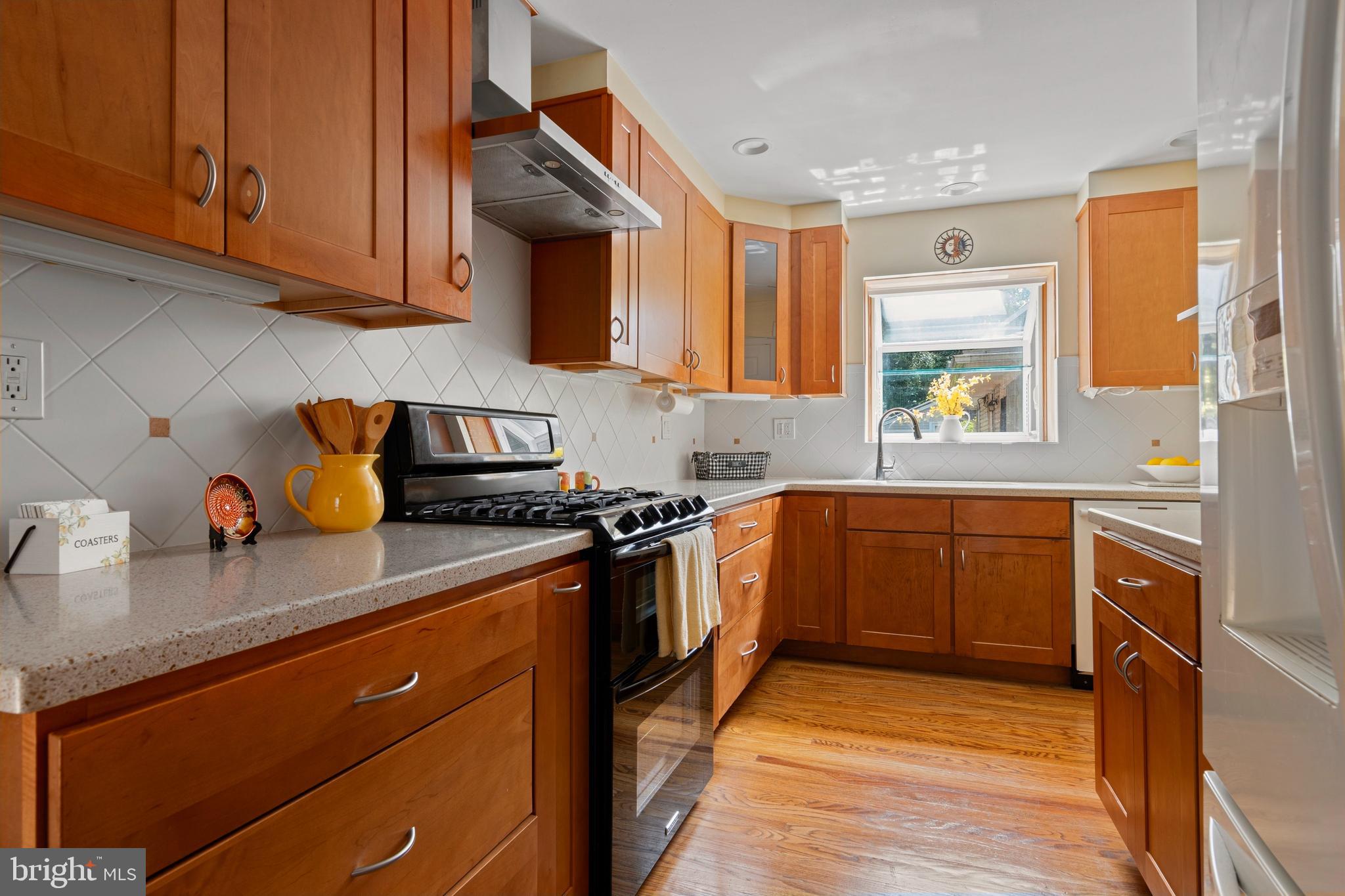 5020 Dermond Road Drexel Hill, PA 19026 - Photo 16 of 39 a kitchen with stainless steel appliances granite countertop wooden cabinets stove top oven and sink