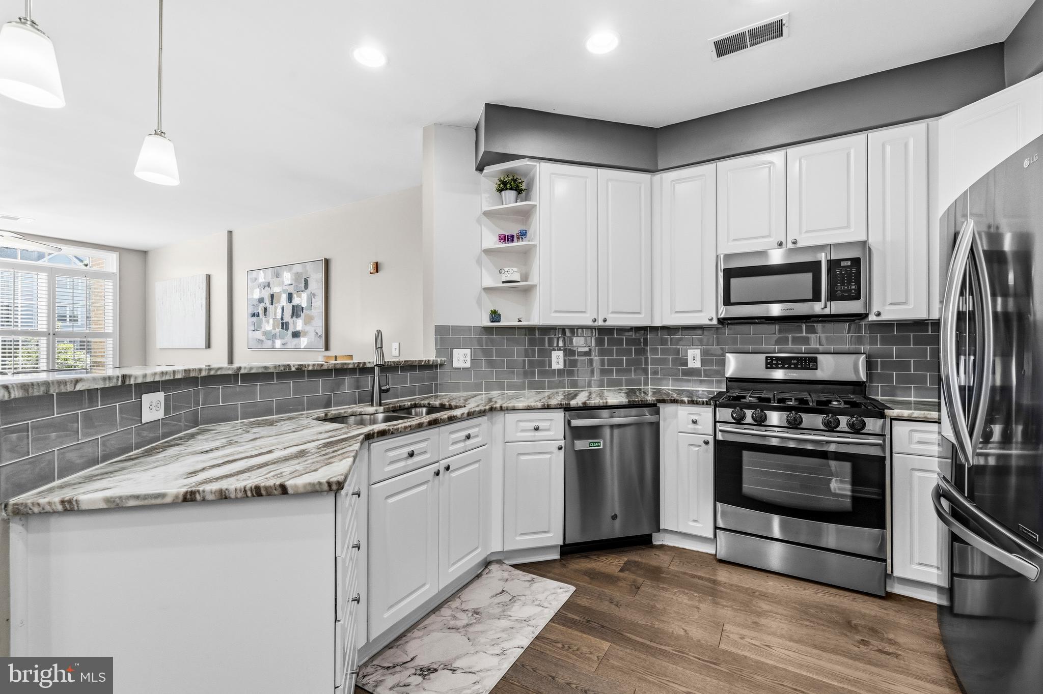 7706 Haynes Point Way, Unit D Alexandria, VA 22315 - Photo 11 of 27 a kitchen with stainless steel appliances granite countertop a stove a sink and a microwave