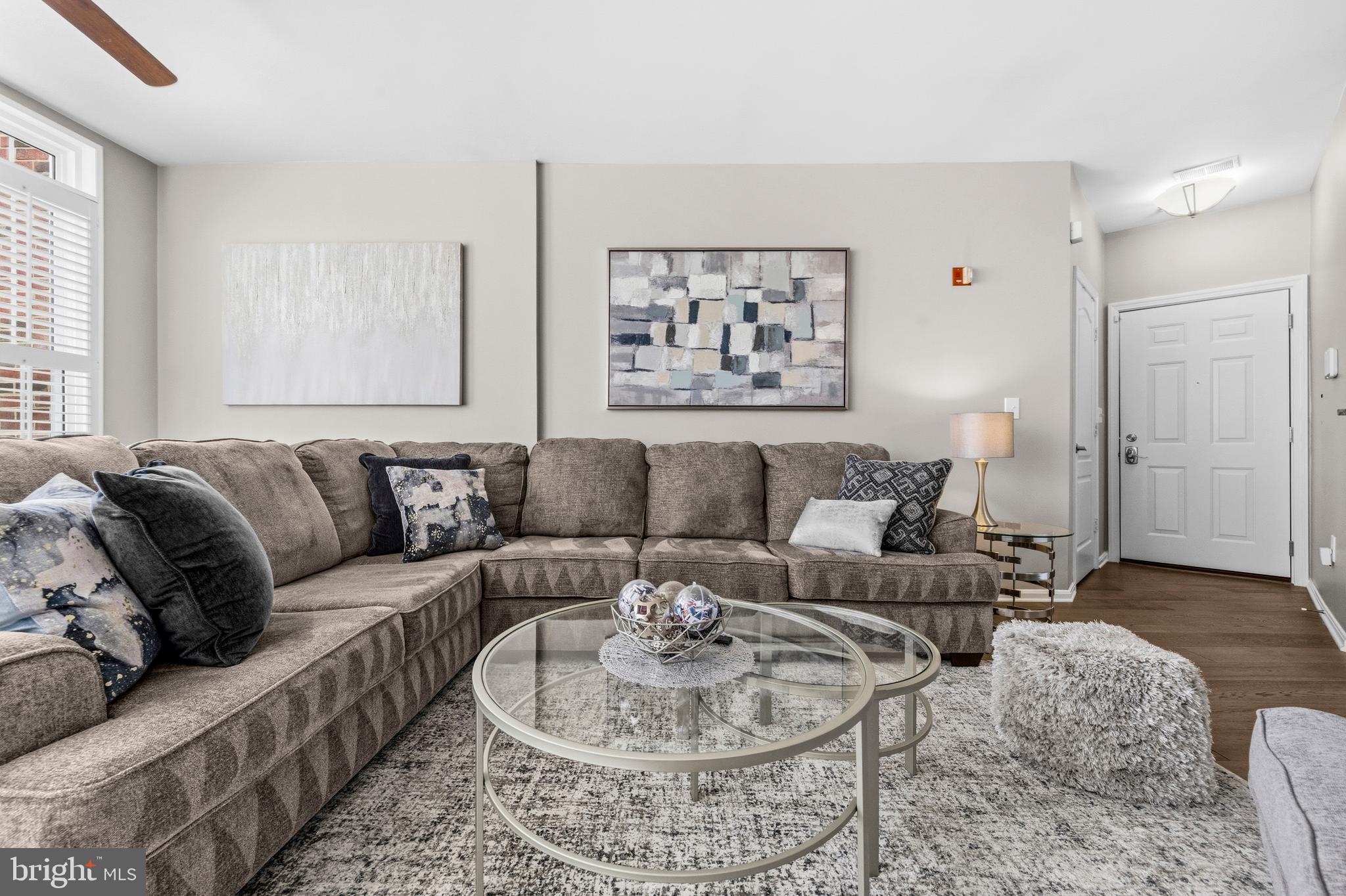 7706 Haynes Point Way, Unit D Alexandria, VA 22315 - Photo 4 of 27 a living room with furniture and a large window