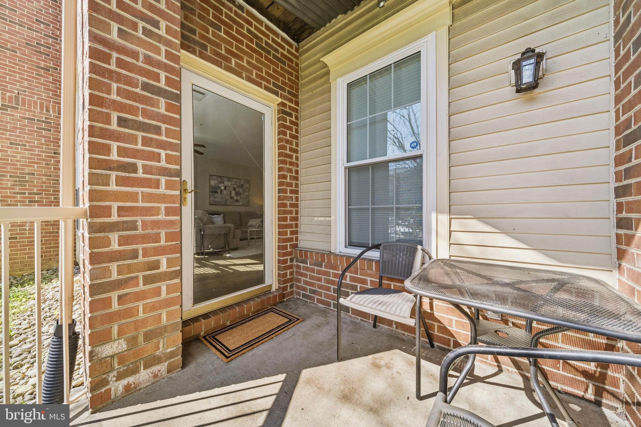7706 Haynes Point Way, Unit D Alexandria, VA 22315 - Photo 6 of 27 a view of a brick house with a chairs and table in a patio