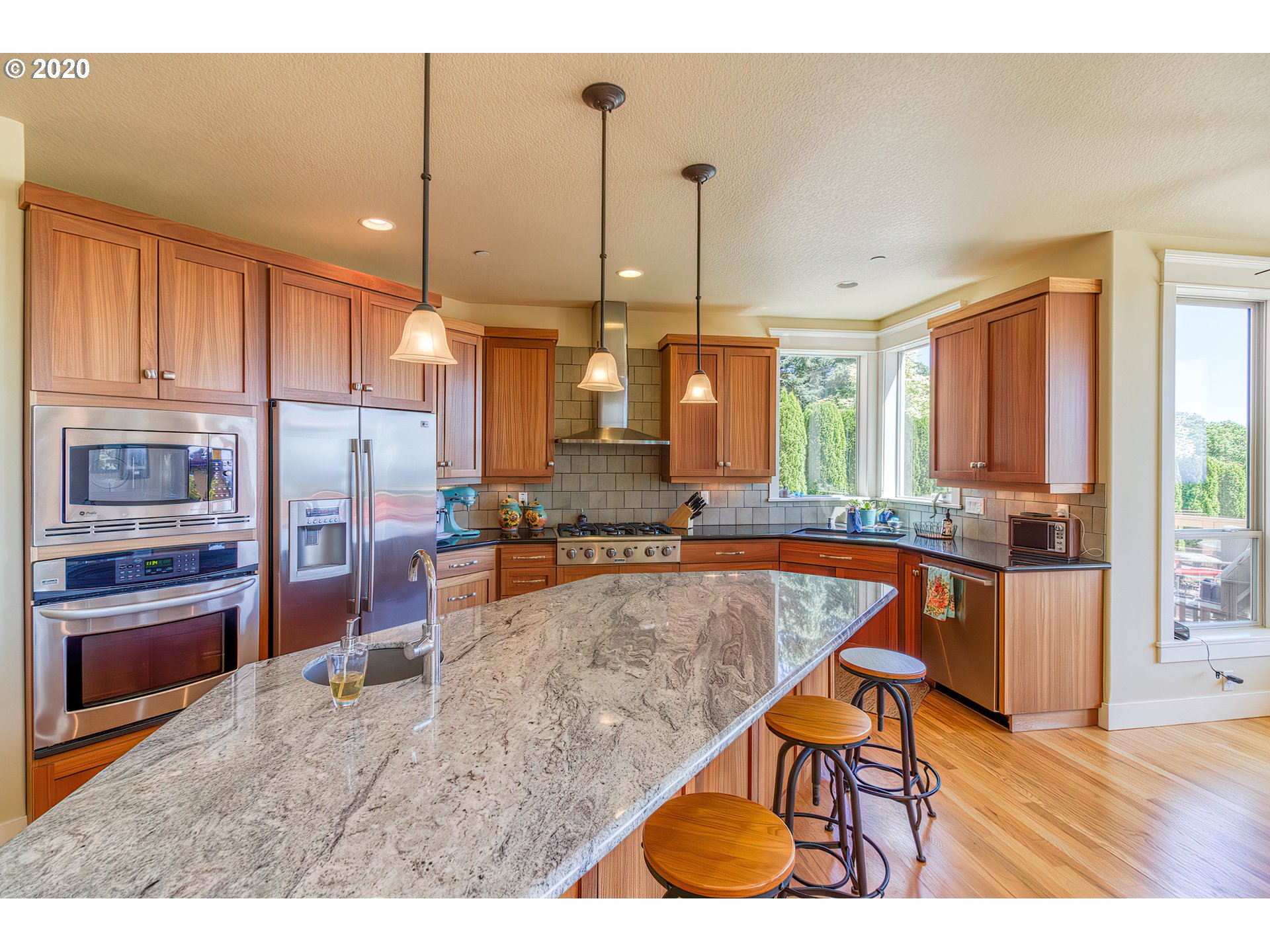 17420 Southwest Parrett Mountain Road Sherwood, OR 97140 - Photo 11 of 32 a living room with stainless steel appliances kitchen island granite countertop furniture and a kitchen view