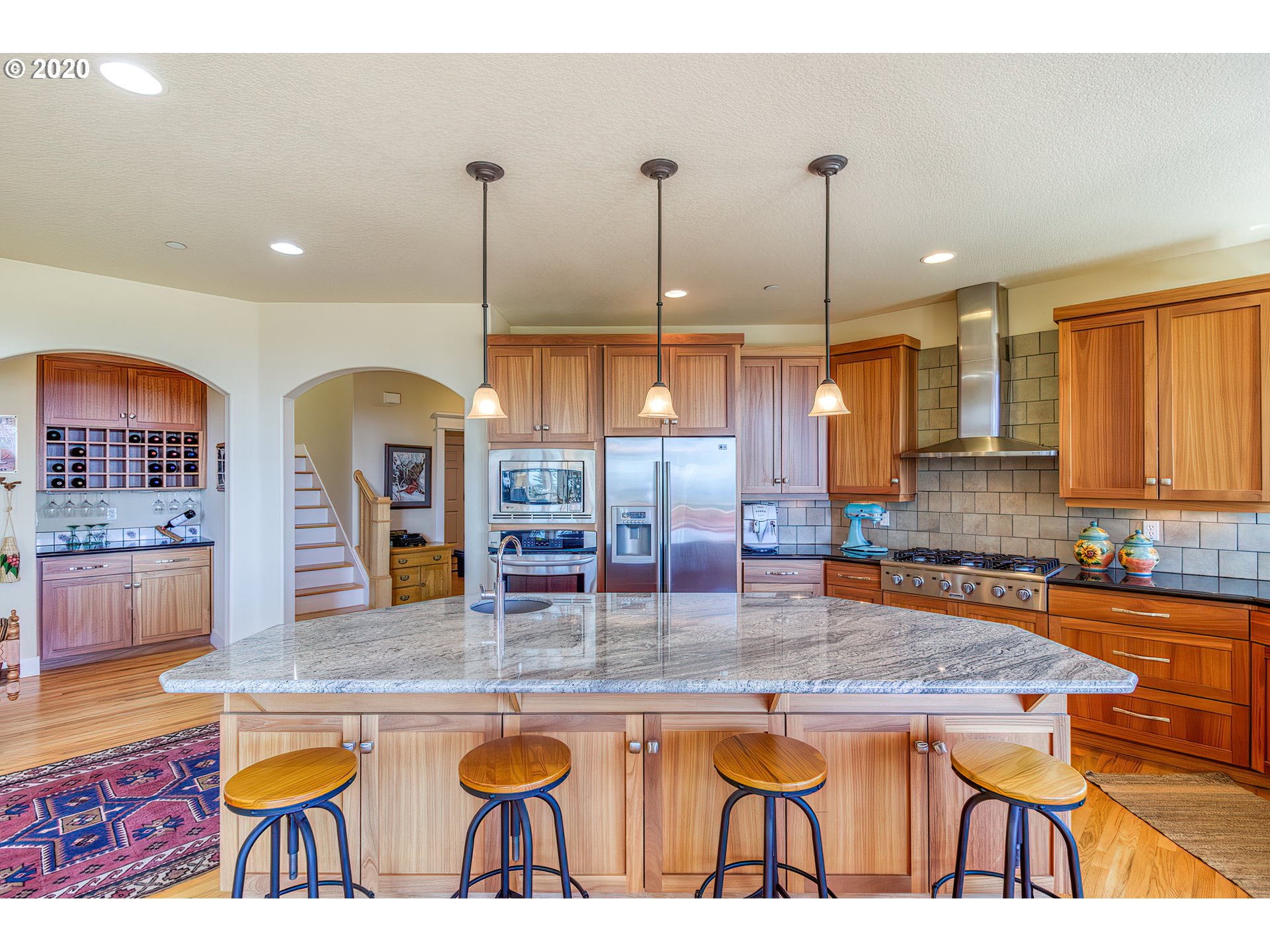 17420 Southwest Parrett Mountain Road Sherwood, OR 97140 - Photo 12 of 32 a kitchen with granite countertop a stove a sink a dining table and chairs