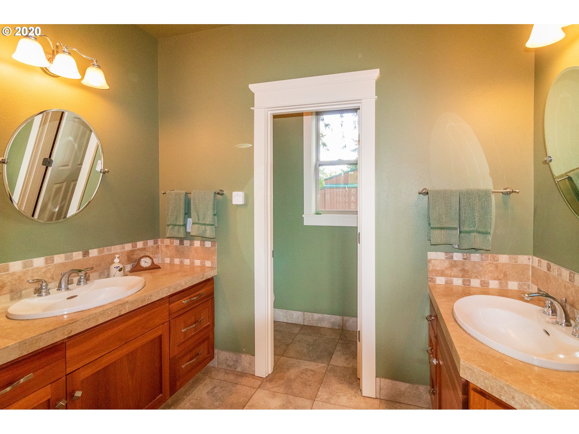17420 Southwest Parrett Mountain Road Sherwood, OR 97140 - Photo 19 of 32 a bathroom with a sink mirror and a shower