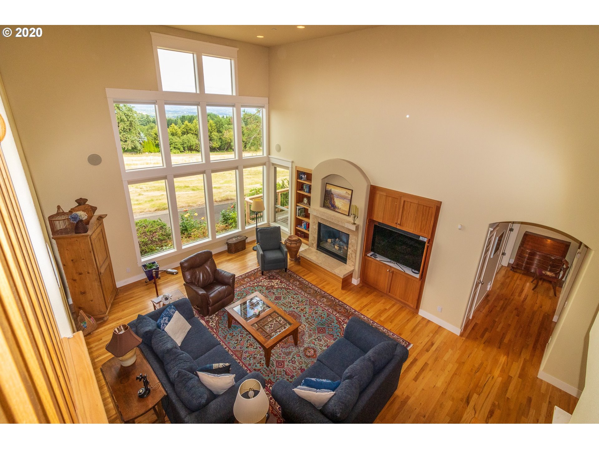 17420 Southwest Parrett Mountain Road Sherwood, OR 97140 - Photo 20 of 32 a living room with furniture and a floor to ceiling window