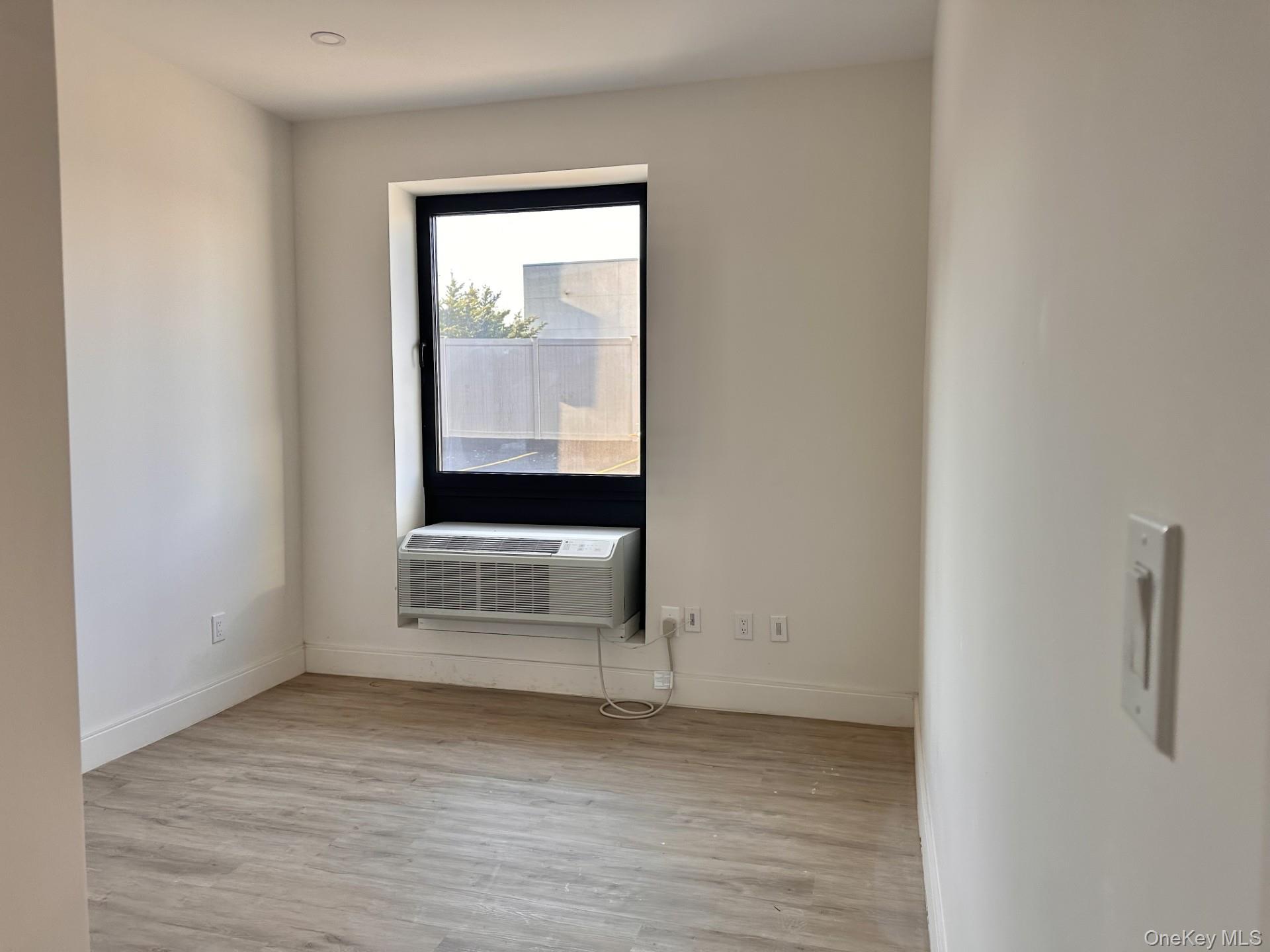 362 West Merrick Road, Unit 107 Valley Stream, NY 11580 - Photo 3 of 7 Unfurnished room featuring light wood-style floors and cooling unit