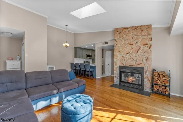 a living room with furniture a dining table and a fireplace