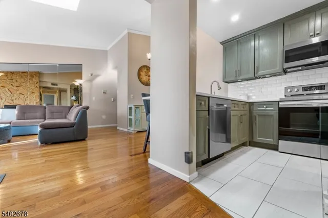 a kitchen with stainless steel appliances a refrigerator stove and microwave