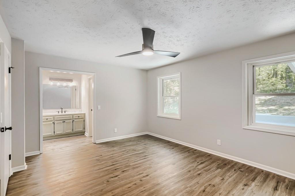 2021 Irwin Bridge Road Northwest Conyers, GA 30012 - Photo 26 of 43 wooden floor in an empty room with a window