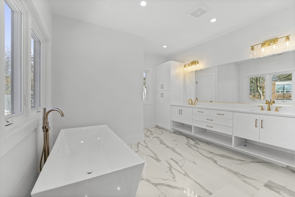 345 Central Avenue Needham, MA 02494 - Photo 21 of 33 a bathroom with a bathtub sink and mirror
