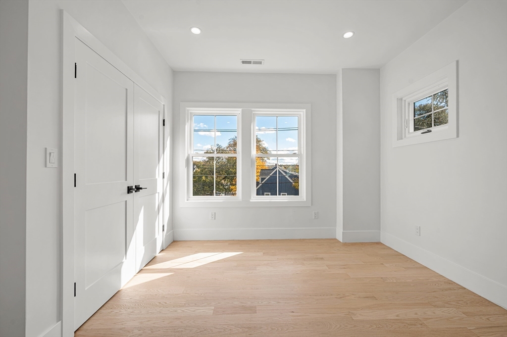 345 Central Avenue Needham, MA 02494 - Photo 22 of 33 an empty room with windows and closet