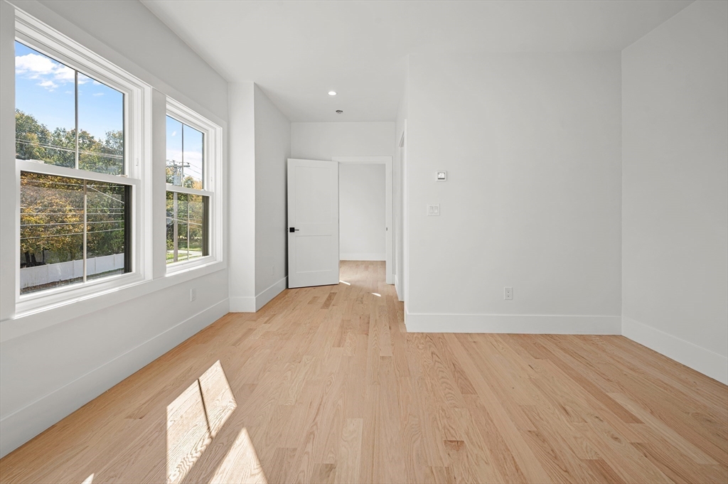 345 Central Avenue Needham, MA 02494 - Photo 24 of 33 a view of an empty room with wooden floor and a window