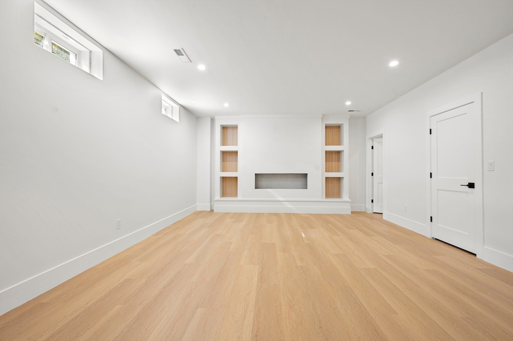 345 Central Avenue Needham, MA 02494 - Photo 27 of 33 a view of empty room with wooden floor and window