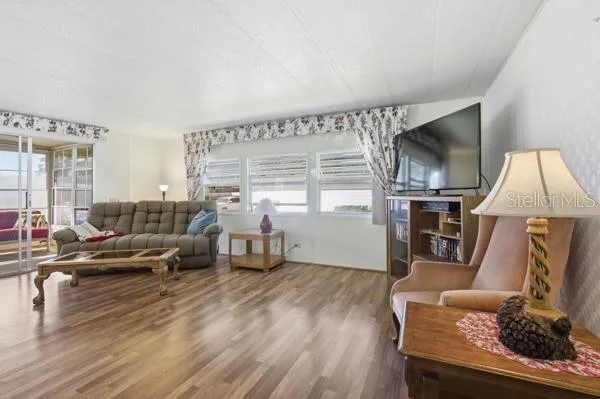 a living room with furniture fireplace and flat screen tv