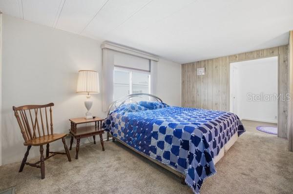 101 Mango Cove Leesburg, FL 34748 - Photo 15 of 28 a bedroom with a bed chair and window