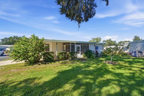 101 Mango Cove Leesburg, FL 34748 - Photo 27 of 28 a front view of a house with a yard