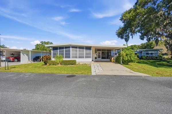 101 Mango Cove Leesburg, FL 34748 - Photo 3 of 28 a view of house outdoor space yard and front view of a house