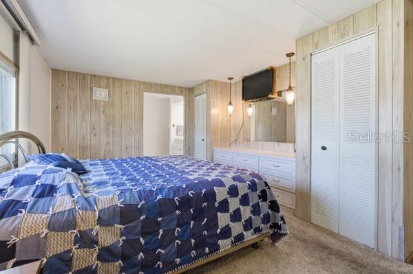 101 Mango Cove Leesburg, FL 34748 - Photo 9 of 28 a bedroom with a bed and flat tv screen