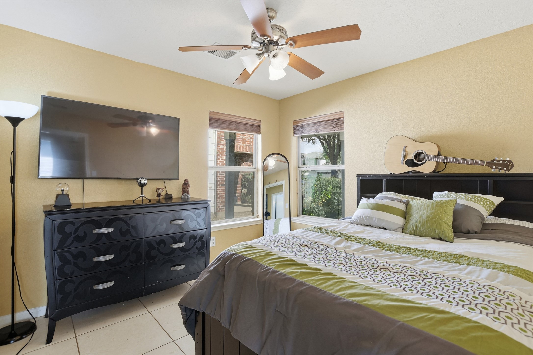 7819 Pasture Spring Lane Cypress, TX 77433 - Photo 14 of 22 a bedroom with a bed and a chandelier