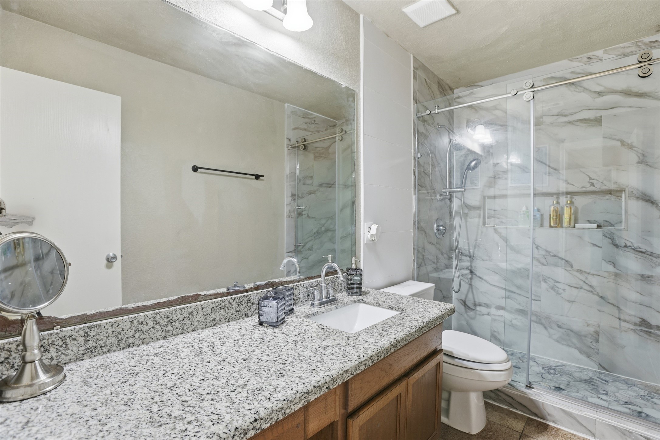 7819 Pasture Spring Lane Cypress, TX 77433 - Photo 15 of 22 a bathroom with a granite countertop sink toilet and shower
