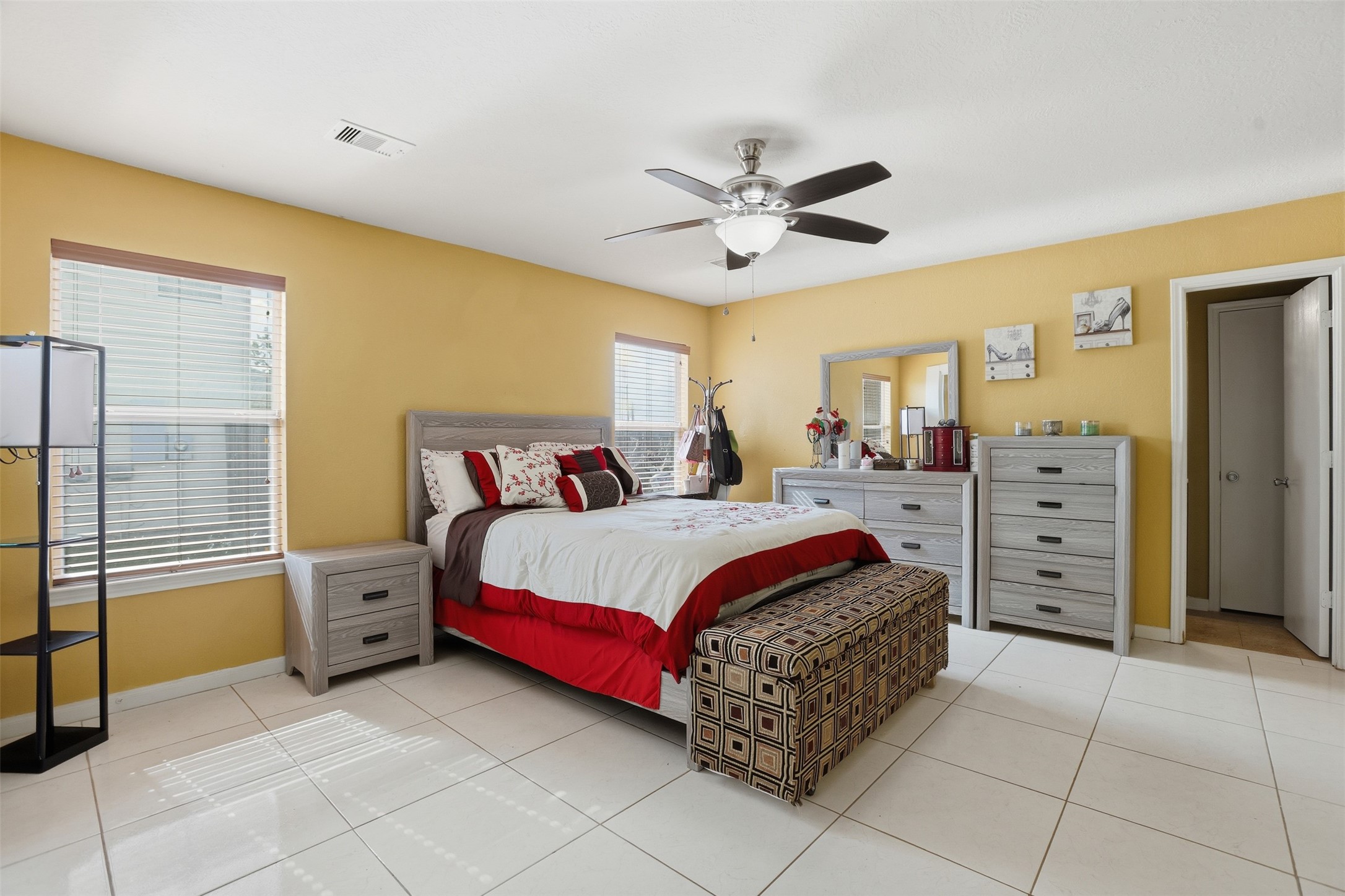 7819 Pasture Spring Lane Cypress, TX 77433 - Photo 18 of 22 a bedroom with a large bed and a chandelier