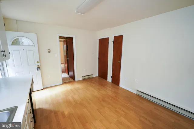 an empty room with windows and chandelier