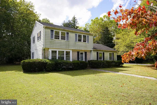 a front view of a house with a garden and yard