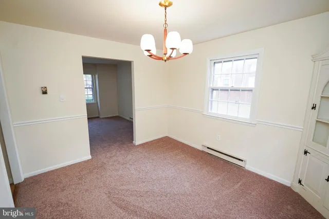 a view of a hallway with a chandelier
