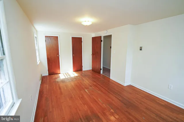 a view of walk in closet with wooden floor