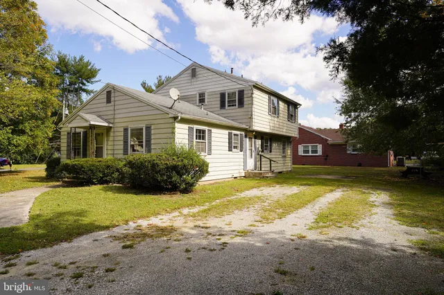 a front view of a house with swimming pool having outdoor seating