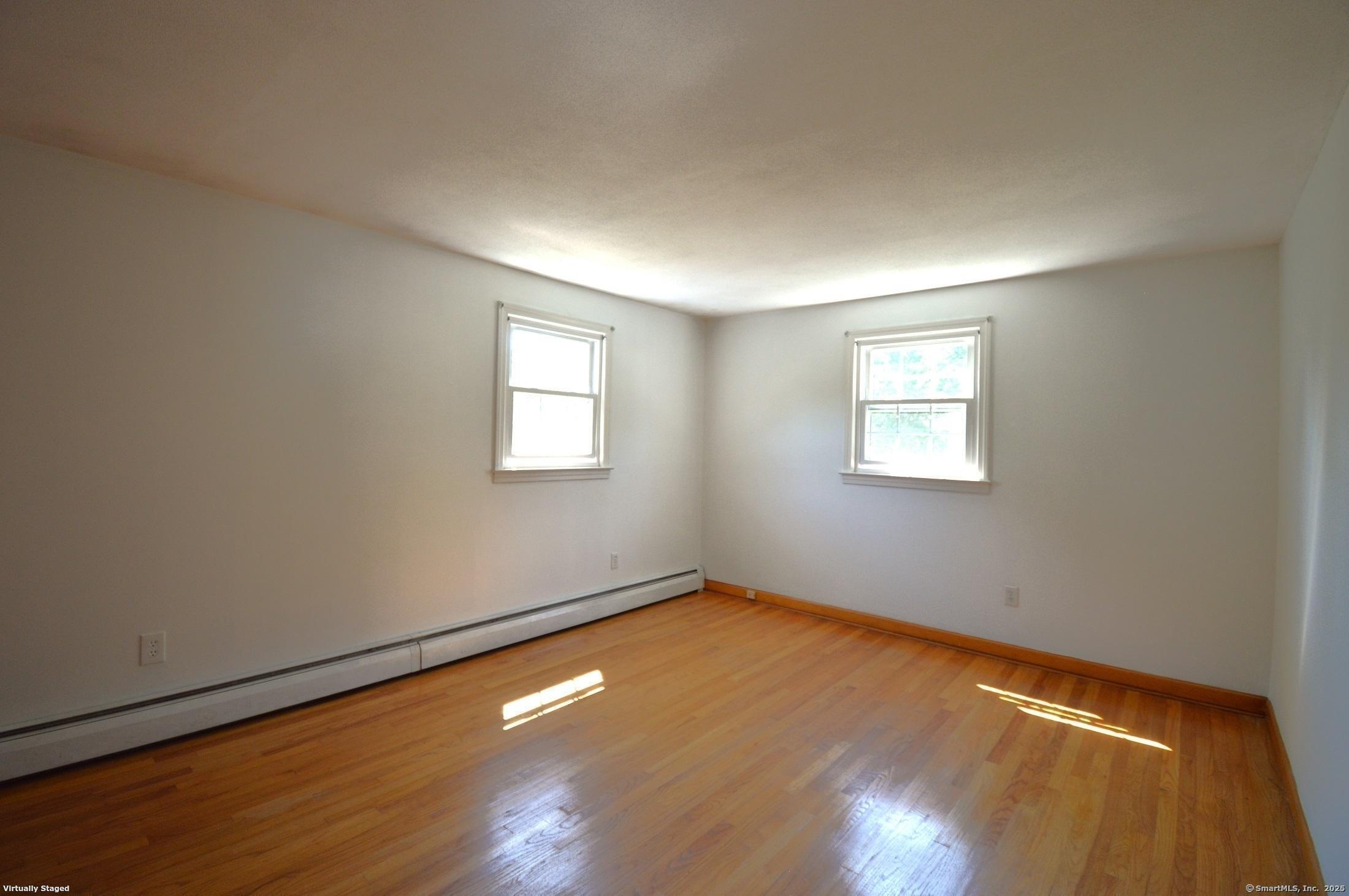 18 Overbrook Road West Hartford, CT 06107 - Photo 18 of 37 an empty room with wooden floor and windows